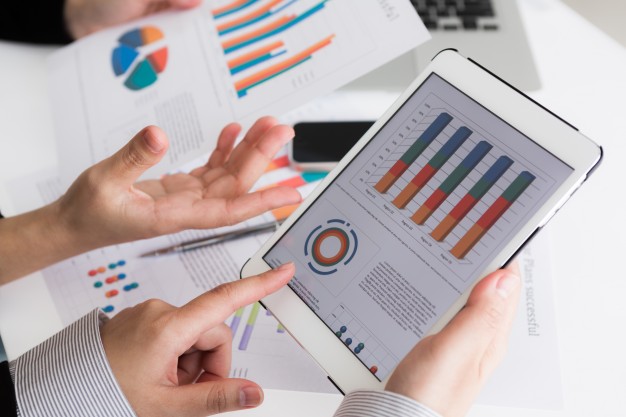 كيفية عمل دراسة جدوى بالدوحة ؟ close up of business team using digital tablet with financial d 1232 2081 - كيفية عمل دراسة جدوى بالدوحة ؟