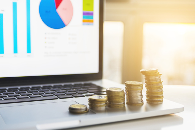 خمس نقاط لدراسة الجدوى من أفضل مكتب دراسات جدوى بالدوحة coins stacks on laptop 23 2147931179 - خمس نقاط لدراسة الجدوى من أفضل مكتب دراسات جدوى بالدوحة