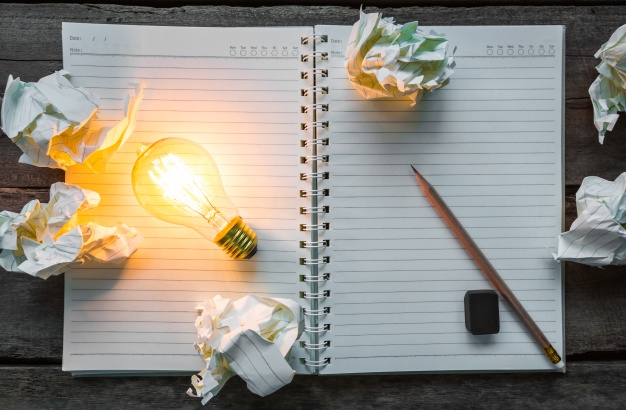 بعض الأخطاء يجب تجنبها عند إعداد دراسة جدوى بأبوظبي top view of lit light bulb on a notebook 1232 673 - بعض الأخطاء يجب تجنبها عند إعداد دراسة جدوى بأبوظبي